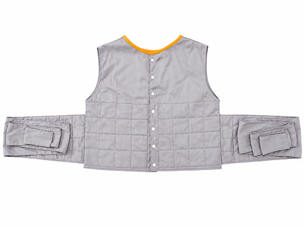 Patient positioning vest in gray with orange trim on a clean white background